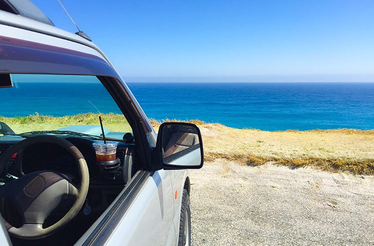 車の運転席側から見た海岸沿いの風景
